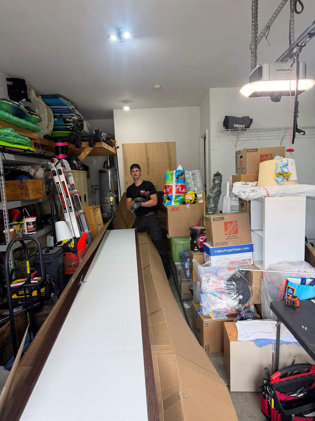 Dad & Daughter garage door project, technician unboxing new garage door panels before installation
